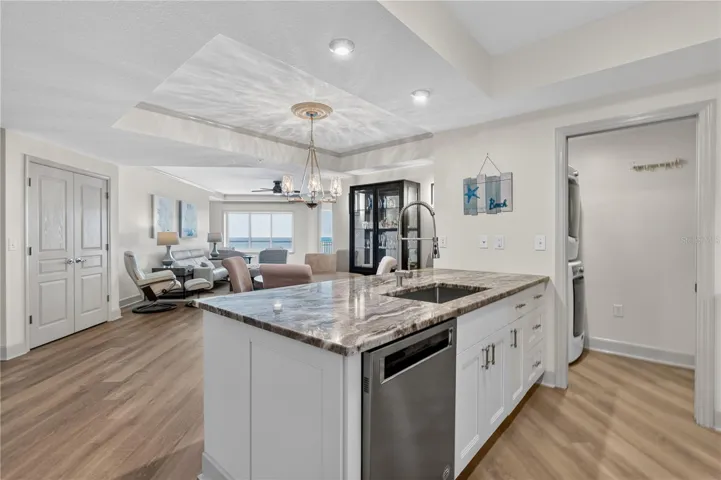 By opening the wall and extending the kitchen island, the design now draws your eye naturally toward the ocean views beyond.
