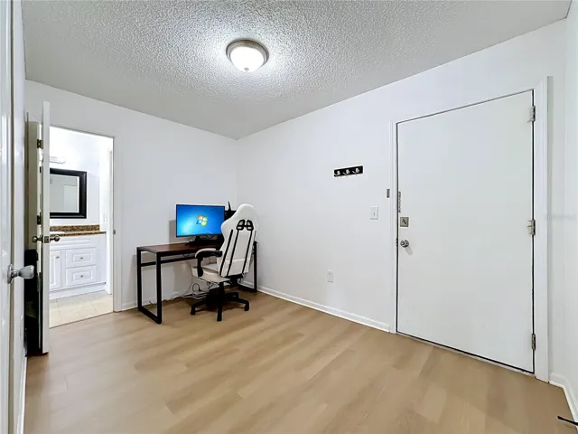 Front door opens up into a multi purpose space currently being used as a home office.