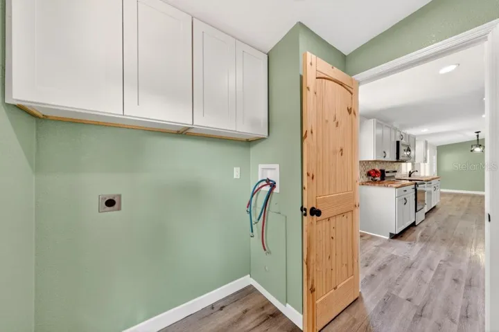 Laundry Room - New washer and dryer hook ups, New dryer vent, New cabinets. New exterior door with window