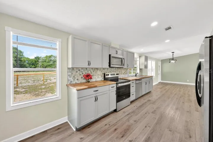 Kitchen - Look at the cabinets, BEAUTIFUL Counters, new fixtures and newer appliances and New Tile Backsplash!