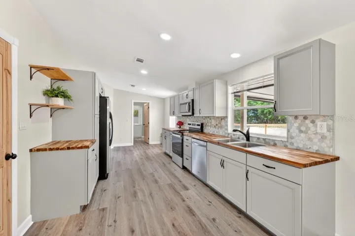 Kitchen - Look at the cabinets, BEAUTIFUL Counters, new fixtures and newer appliances and New Tile Backsplash!