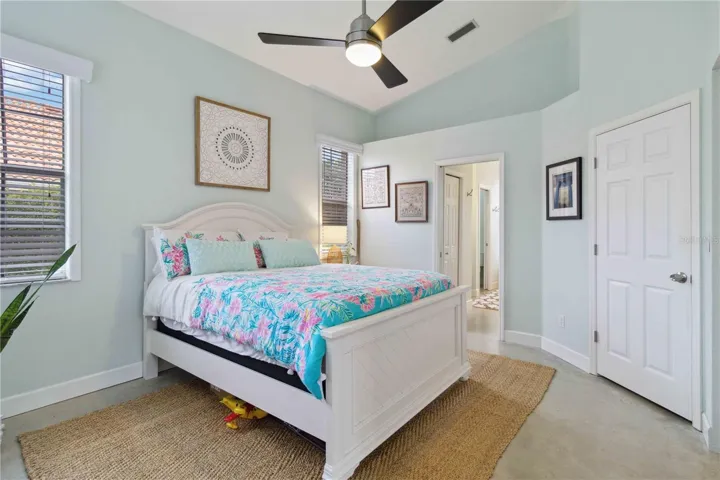 Your light & bright main bedroom with ceiling fan & ample storage options.
