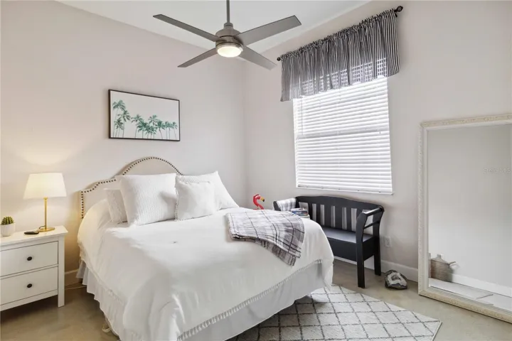 The second guest bedroom which has a ceiling fan.