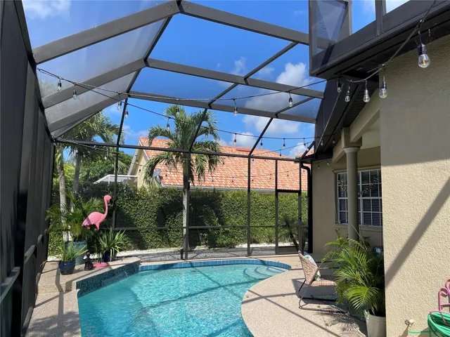 Ample space to entertain around the caged pool.