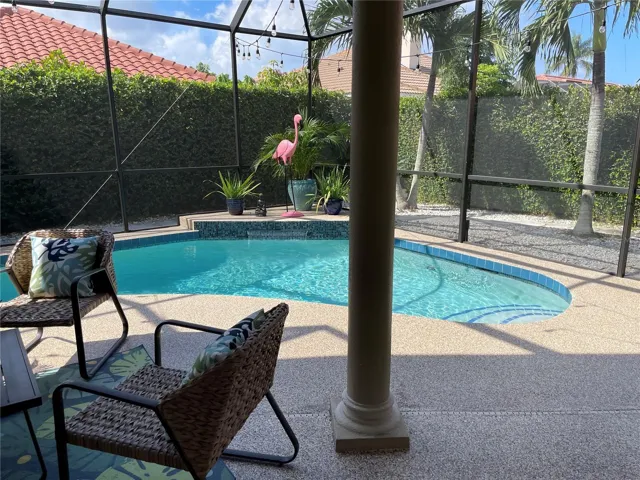 Dine al fresco around the caged pool & enjoy the waterfall.
