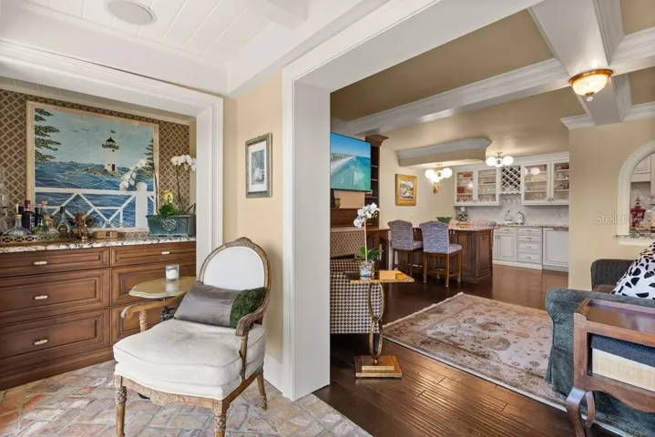 Enclosed Sun Room Features Dry Bar and Chicago Brick Flooring with double pained soundproof sliding doors with views of the downtown Orlando skyline