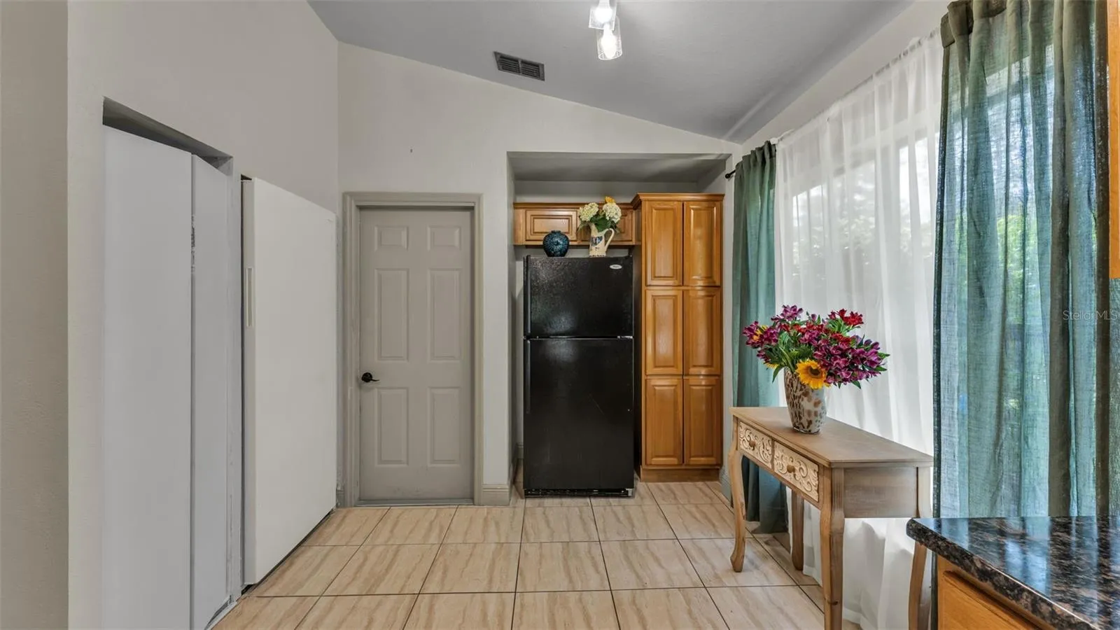 Kitchen towards pantry and garage door