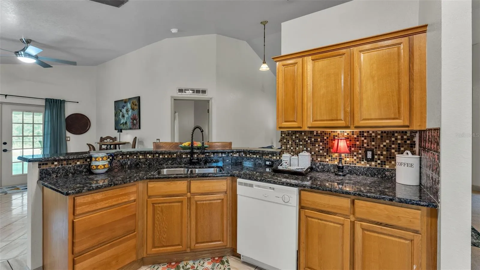 Kitchen towards DR and 4th bedroom that has door that leads to pool