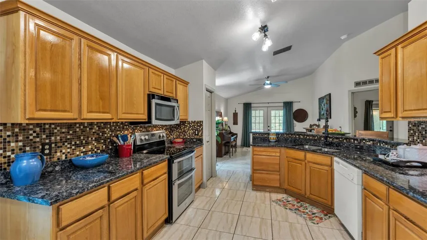 Kitchen from garage door towards DR and back pool door