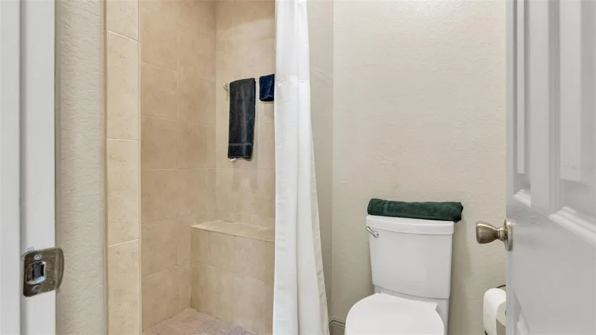 Walk in tiled shower and water closet