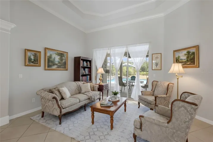 *This photo has been virtually staged* Living Room with Sliders to the Lanai
