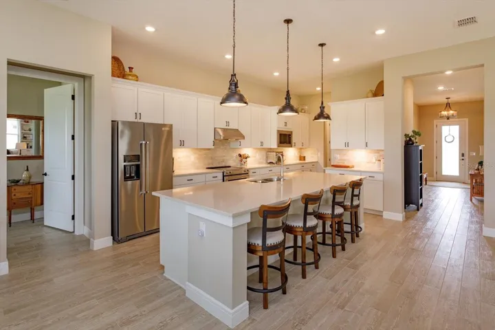 Kitchen with Upgraded Quartz Countertops and Marble Backsplash