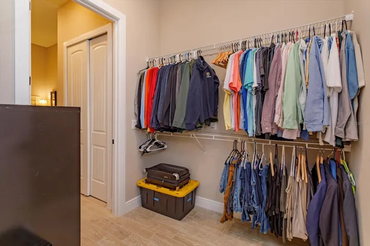 Walk-In Closet in the Primary Suite. Opens into the Spacious Laundry Room