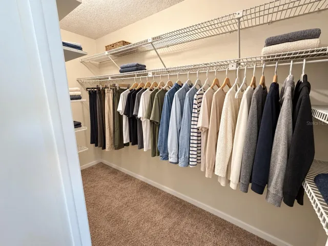primary bedroom walk in closet . After