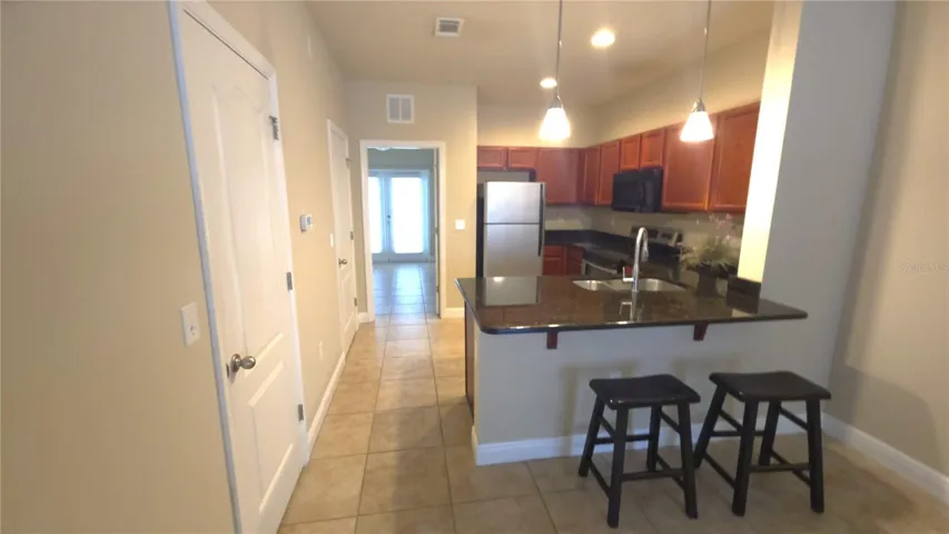 Kitchen with Granite countertop, wood cabinets and SS appliances