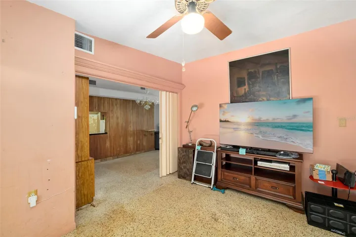 Family room featuring a bathroom with pool access and sliders!