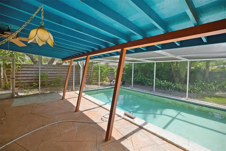 Shaded pool patio with pool cage