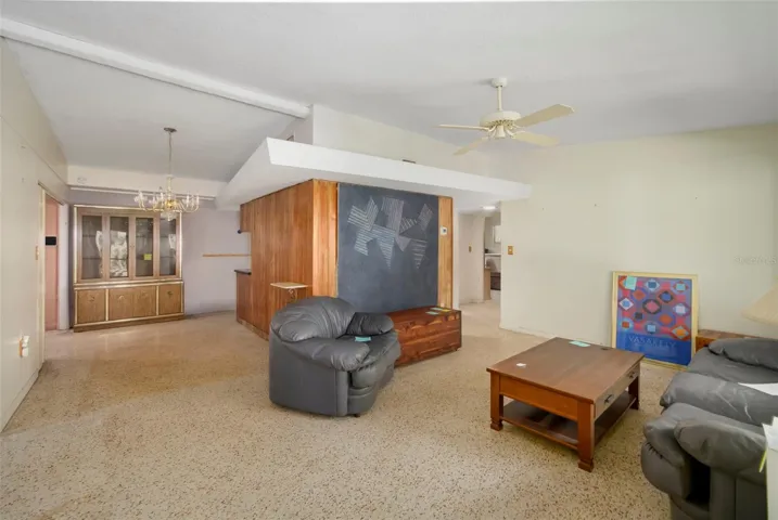 Living room with high ceilings and terrazzo flooring.