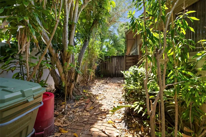 Side front yard with pavers and access to back yard.