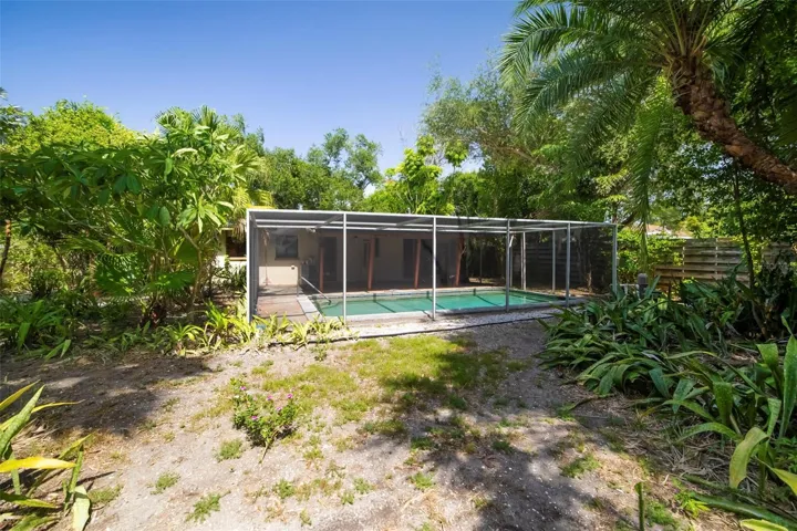 Fenced back yard with ample space for pets and gardening.