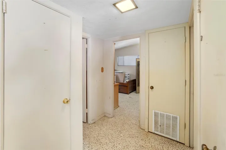 hallway to primary bedroom, secondary bedroom, and full bathroom