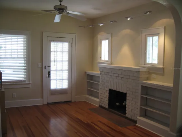Living area hardwood floors with original Built-ins