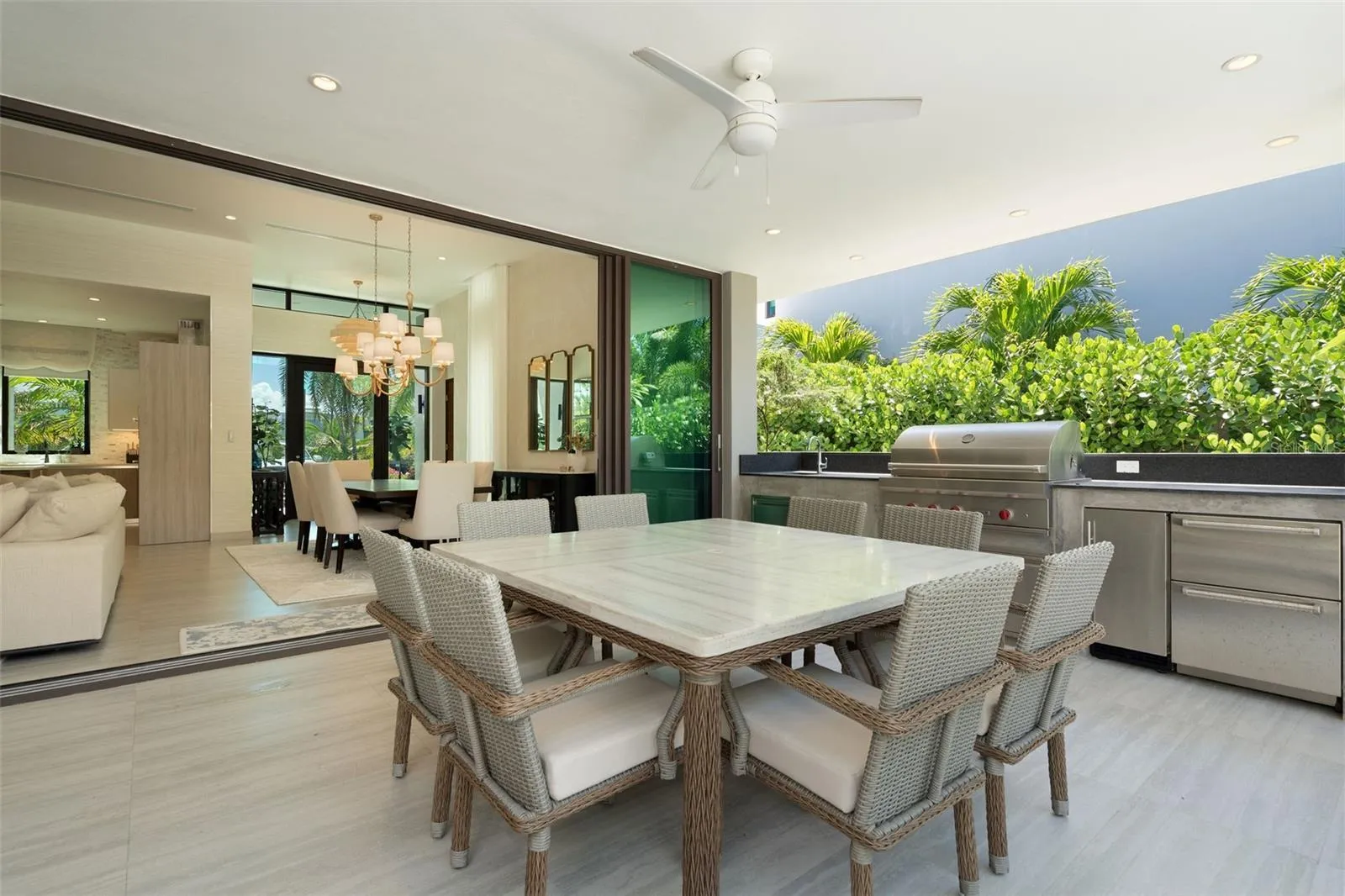 Designed for seamless indoor-outdoor living, the residence opens to a resort-style outdoor area featuring a private pool, covered terrace, outdoor shower, and built-in BBQ kitchen space including a Wolf Grill, perfect for entertaining or relaxed island living.