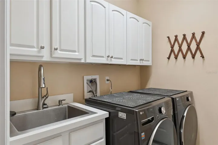 Laundry room with storage and utility sink