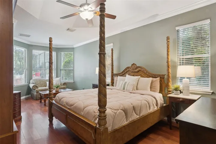 Main level primary suite offers privacy and comfort with views to the pool