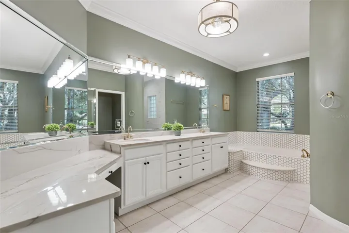 Generous primary bath with dual vanities and garden tub