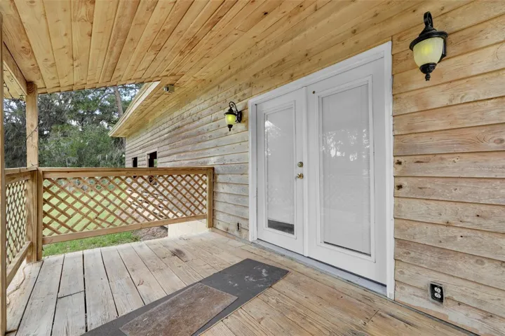Charming, covered porch welcomes you into the attached 2-bedroom apartment, creating a cozy spot to relax and enjoy peaceful country surroundings.