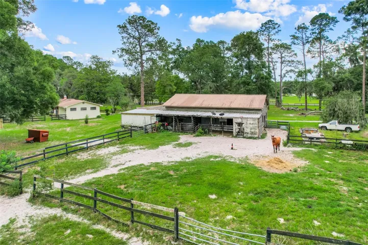 Well-designed paddock area offers convenient space for turnout and exercise, creating a functional connection between the barn and surrounding pasture areas.
