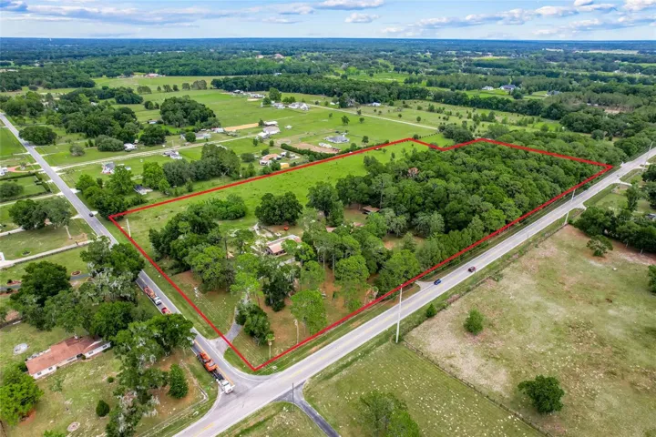 Aerial overview highlighting the property’s impressive footprint, dual road access from County Road 42 and side road frontage, plus abundant space for country living and equestrian potential.