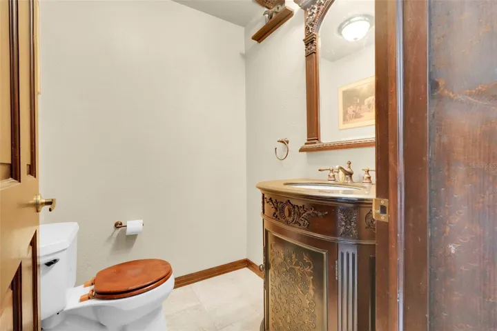 Well-placed half bath serves the adjoining entertainment bonus/flex space with ease.