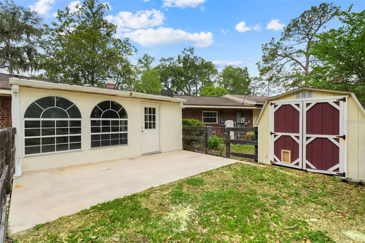Step outside the bonus/flex space to a private outdoor area featuring a storage shed that conveys with the property.