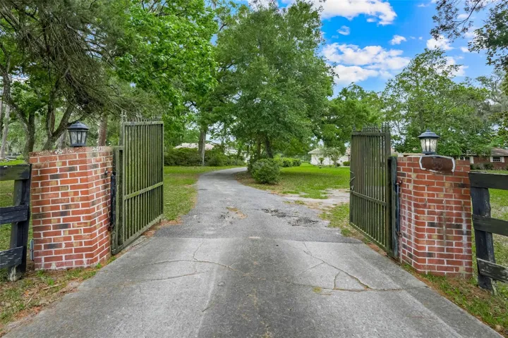 Welcoming gated entrance off SE Highway 42 sets the tone for this private country retreat, offering charm, character, and a beautiful arrival home.