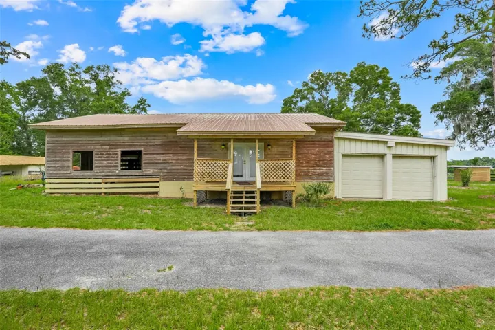 Equestrian-ready amenities include a horse barn with attached 2-bedroom apartment and attached 2-car garage, adding exceptional functionality to the property.