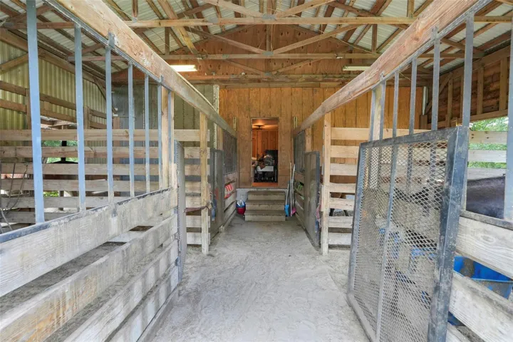 Eight-stall horse barn with steps leading into the apartment.