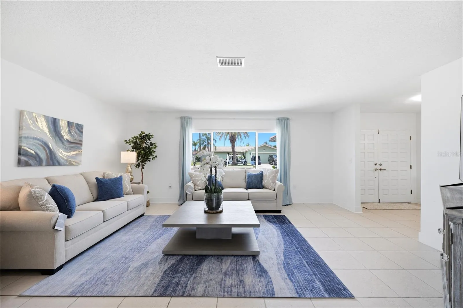 large picture window in living room brings in lots of natural light