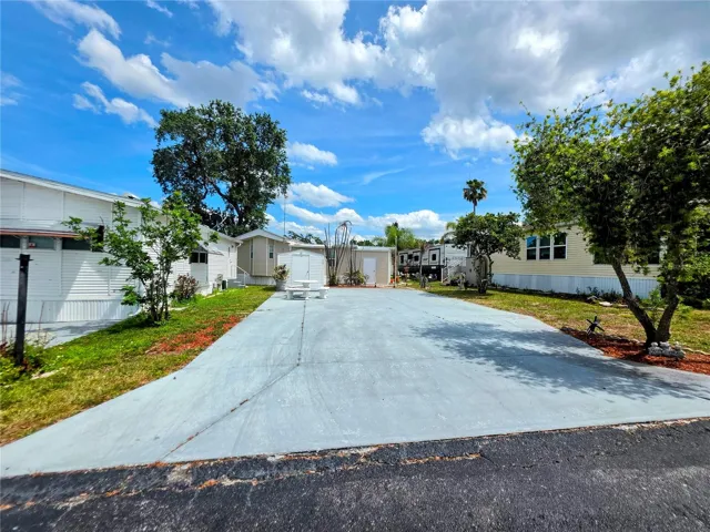 Spacious RV lot with a large concrete pad, offering a comfortable setup and relaxing views of Saddlebag Lake in a 55+ community.