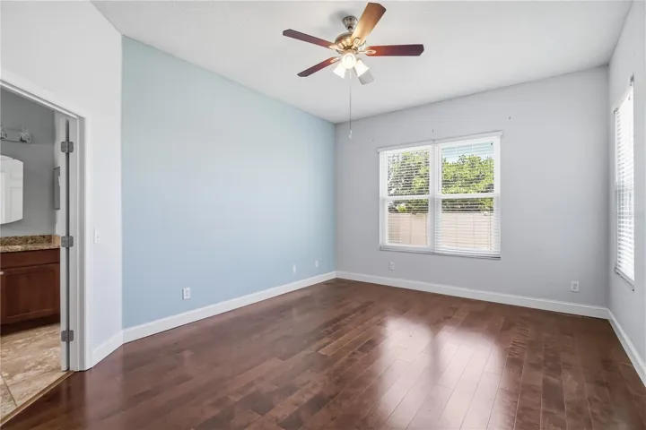 Primary bedroom with warm wood floors