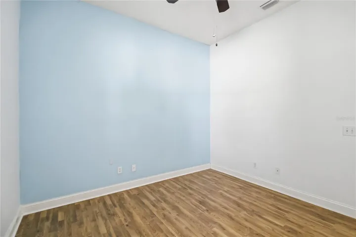 Secondary bedroom with wood style flooring