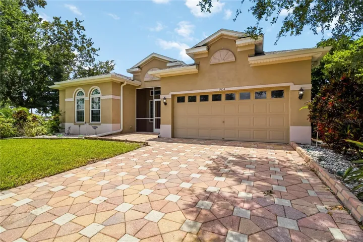 Welcoming front exterior with paver driveway