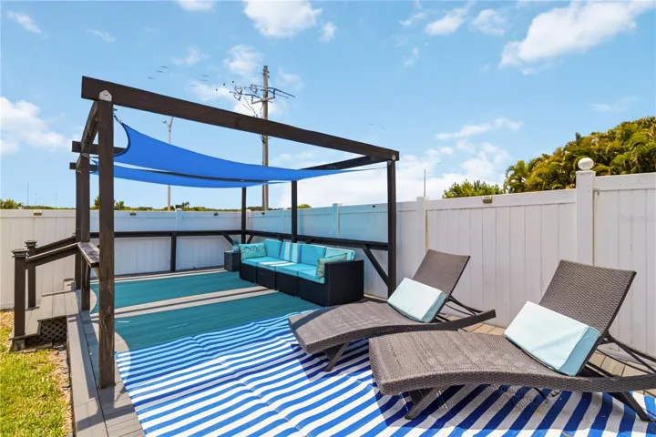 Deck with lounge seating and shade sails