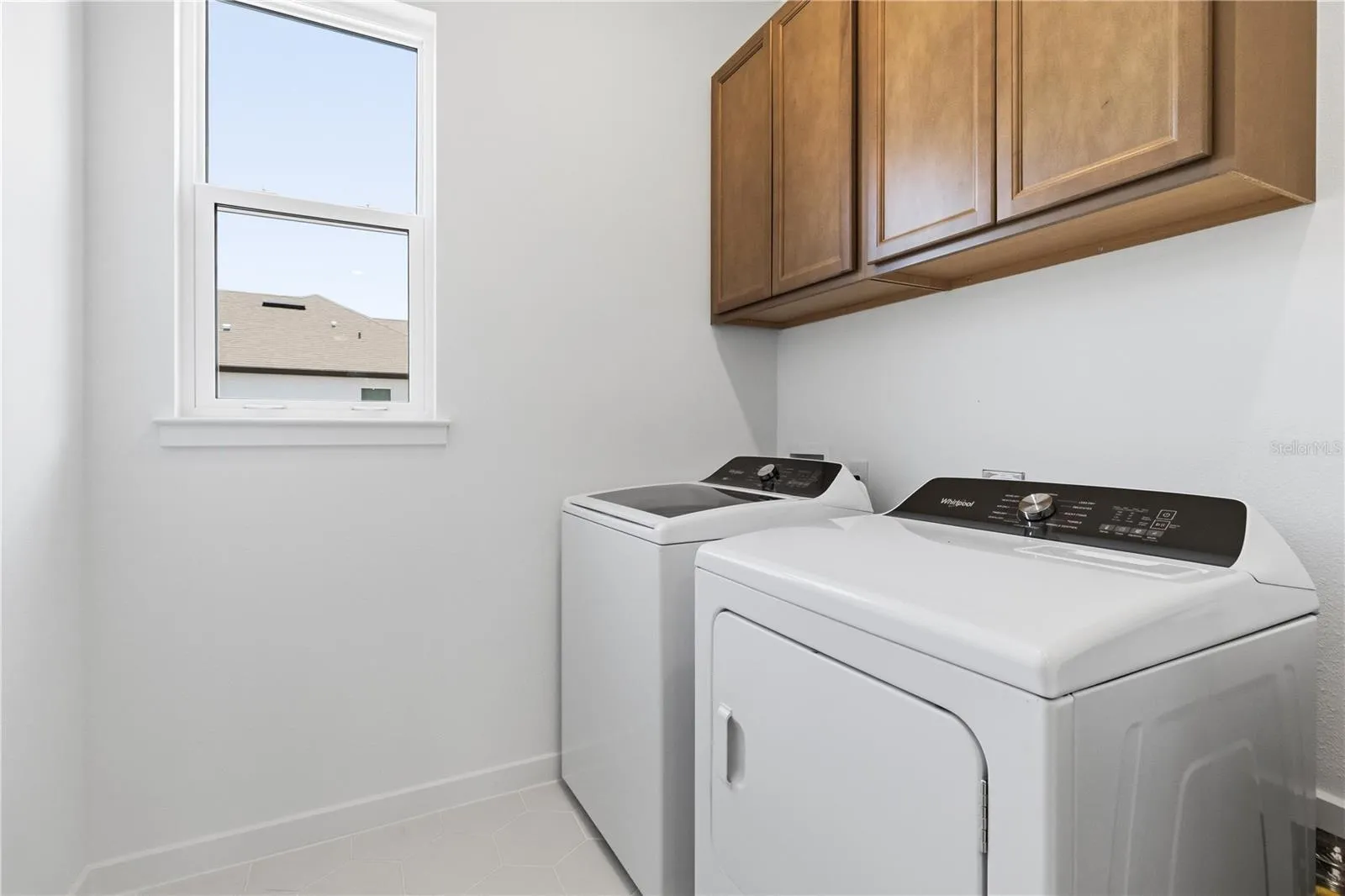Convenient laundry room with built in cabinetry and everyday function.