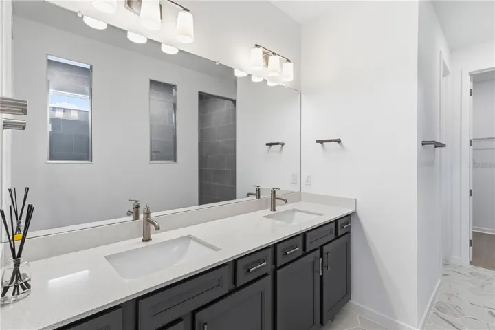 Beautiful primary bath with dual sinks, upgraded finishes, and everyday convenience.
