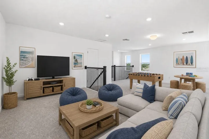 Virtually staged loft showing the perfect setup for movie nights, game days, and casual hangouts.