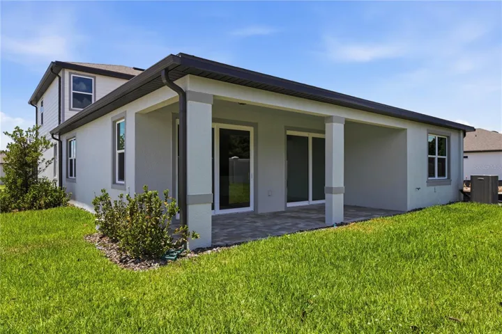 Covered rear lanai and backyard space for grilling, relaxing, and easy Florida evenings.