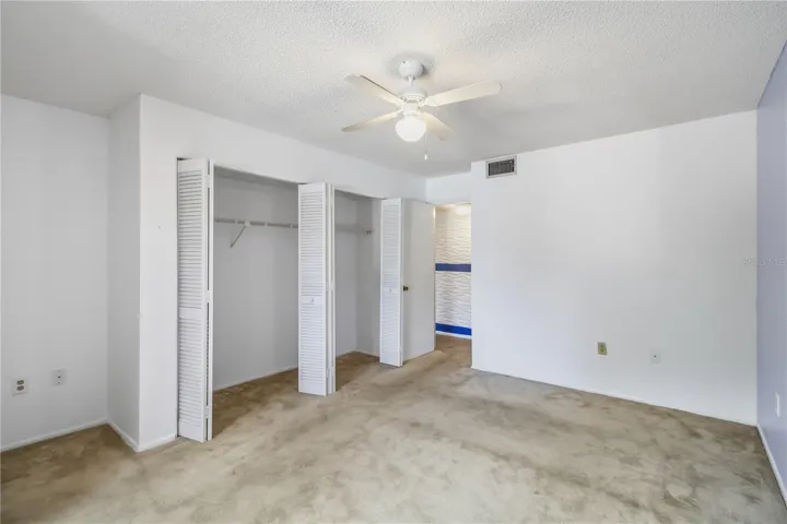 Bedroom with wall length closet storage