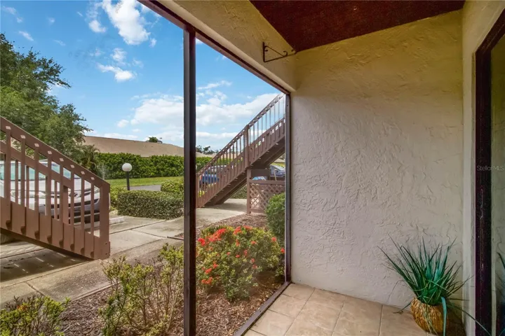 Screened lanai overlooking landscaped grounds